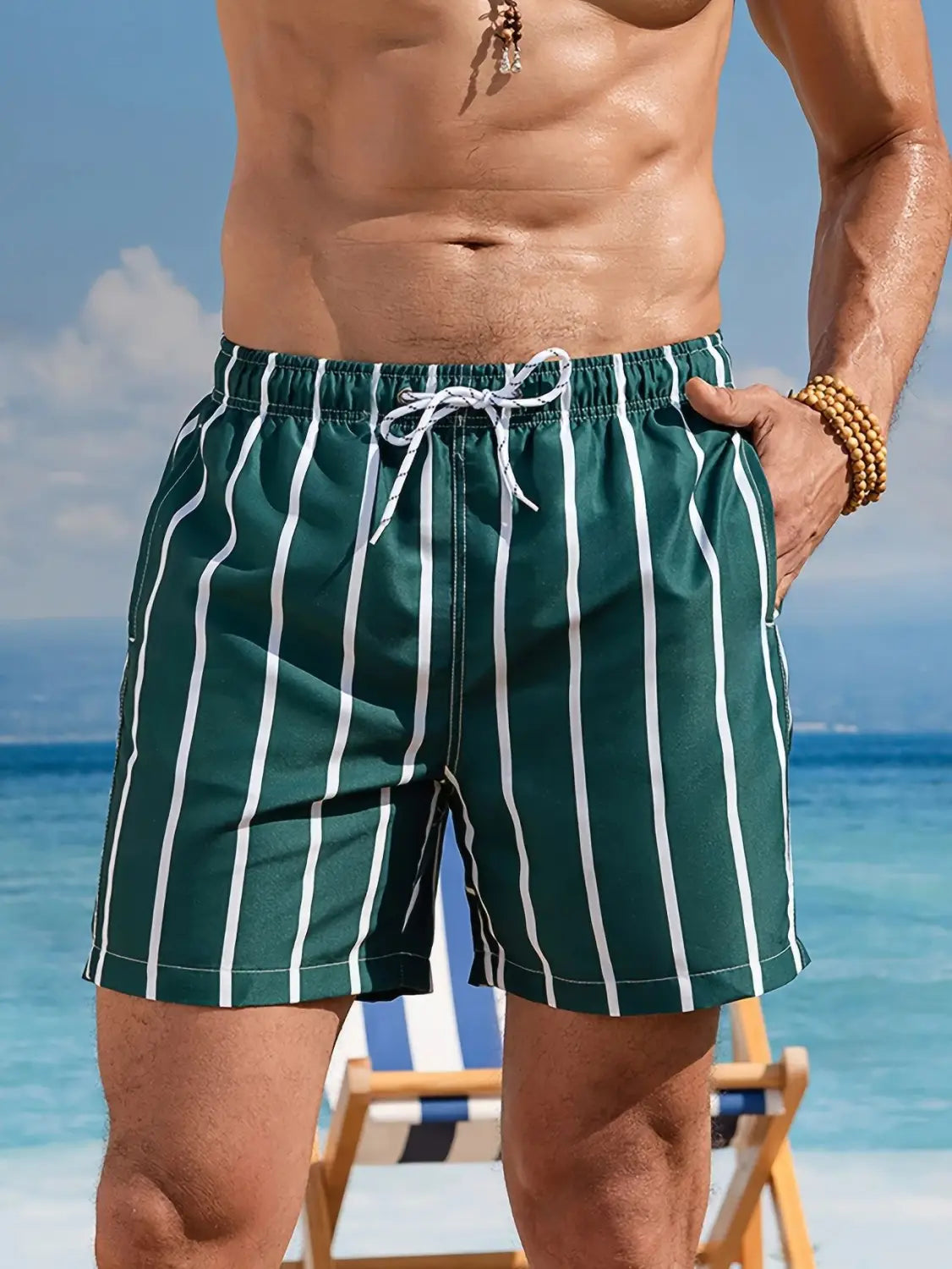 Men casual swim trunks featuring green and white vertically striped fabric with a drawstring waistband designed for tropical boardshorts use.