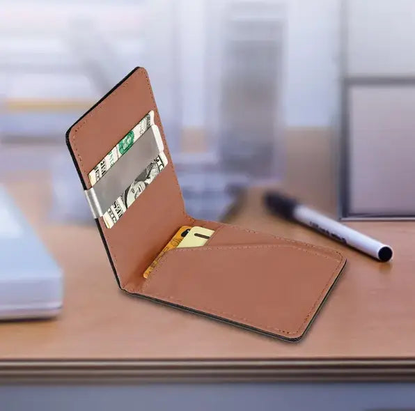 rfid blocking slim pu leather bifold money clip wallet in tan leather with black stitching and a silver metal clip holding cash.