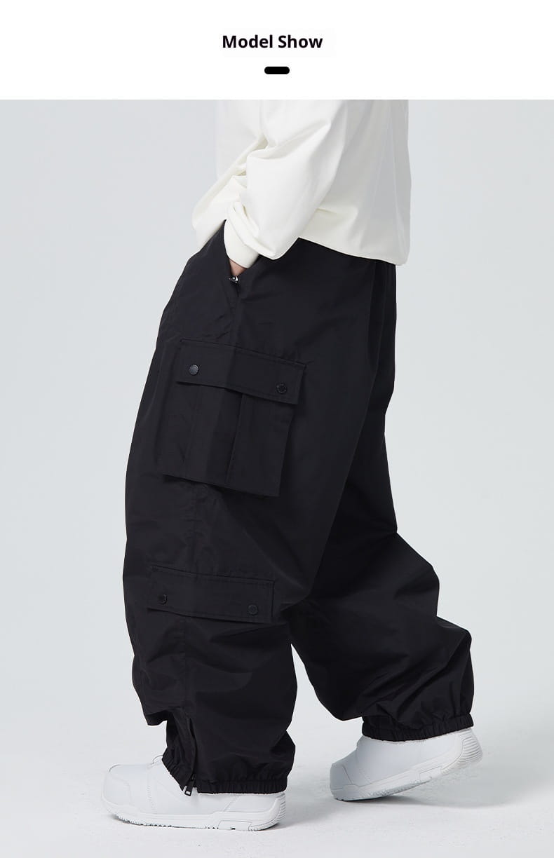 Black winter outdoor loose ski pants with a relaxed fit and multiple flap pockets designed for cold weather activities.