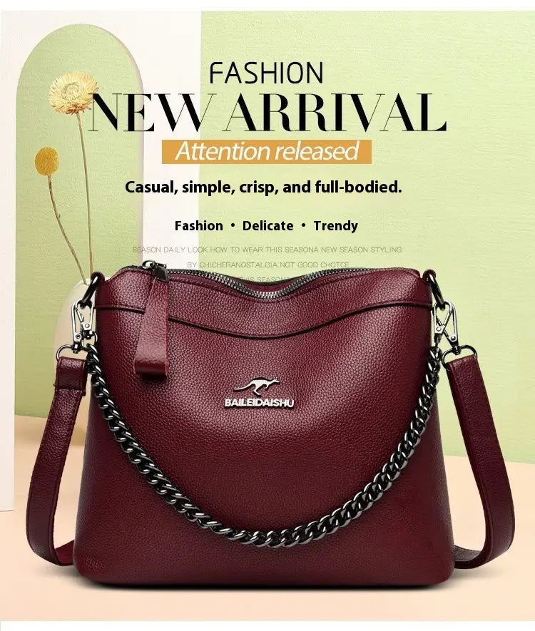 Maroon leather crossbody handbag with silver chain strap and bailedaishu logo.
