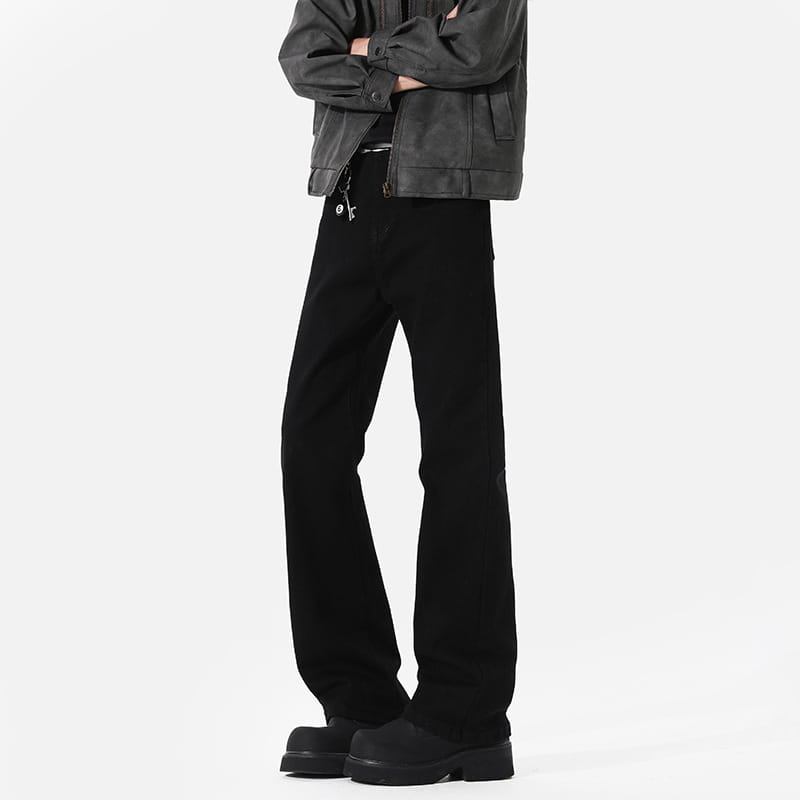 modern black straight leg bootcut denim jeans in black denim featuring a subtle distressed texture and a sleek modern cut