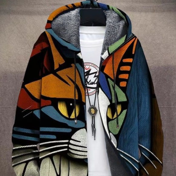 A vibrant graphic-print windproof winter jacket featuring a stylized cat face in bold orange and blue hues with yellow eyes and plush gray fleece lining.