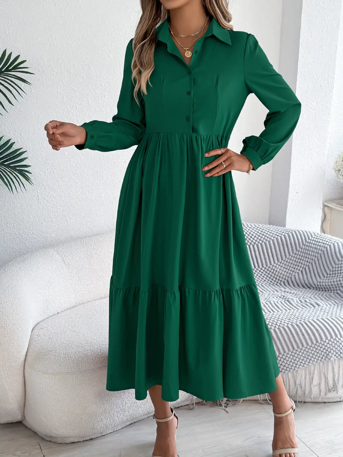 Women’s long sleeve tiered button down midi dress in emerald green with a fitted waist and flowing skirt.