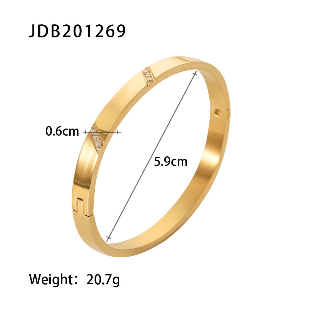 gold-plated stainless steel bangle bracelet in gold tone with a sleek minimalist design and small zirconia gemstone embellishments on the clasp