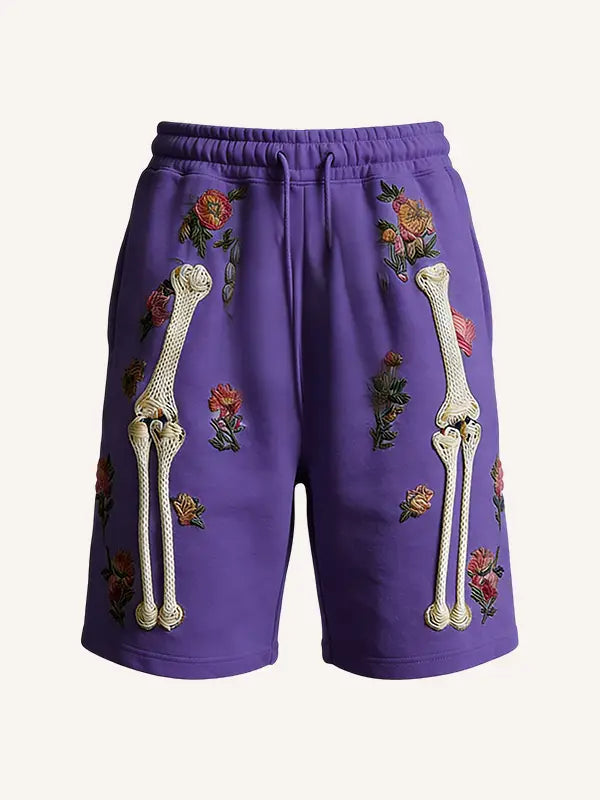 purple polyester sweat shorts featuring embroidered white bone designs and floral patterns for men