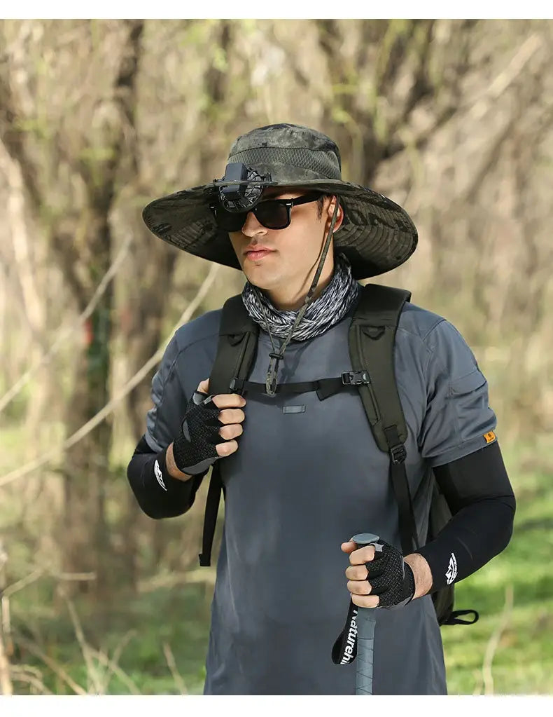 Camouflage-patterned men sun hat with wide brim mesh underside and adjustable strap designed for hiking and camera mounting.