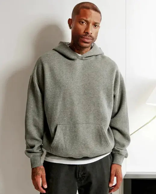 A relaxed-fit heather gray oversized leafy camouflage lantern sleeve hoodie made of soft material with a front pouch pocket and ribbed cuffs.