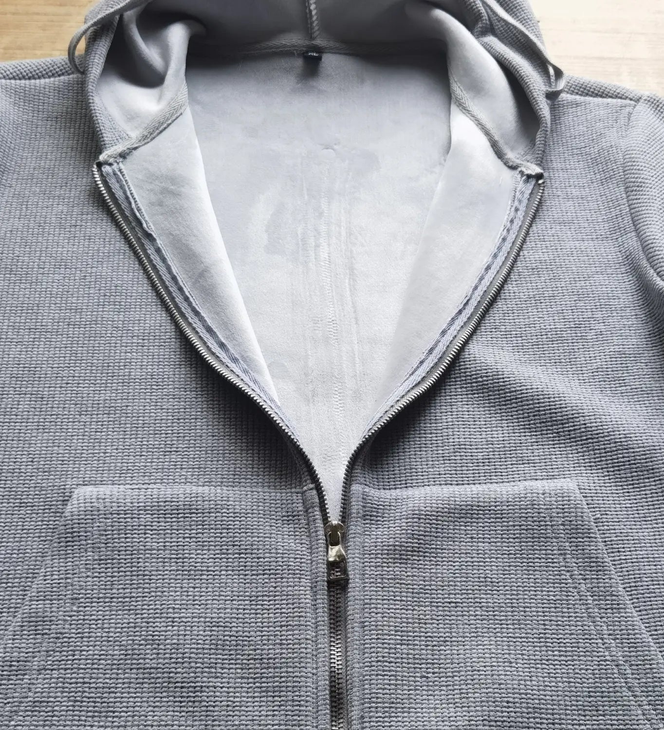 gray textured zip-up waffle hooded sportswear set with soft lighter gray interior lining designed for athletic wear