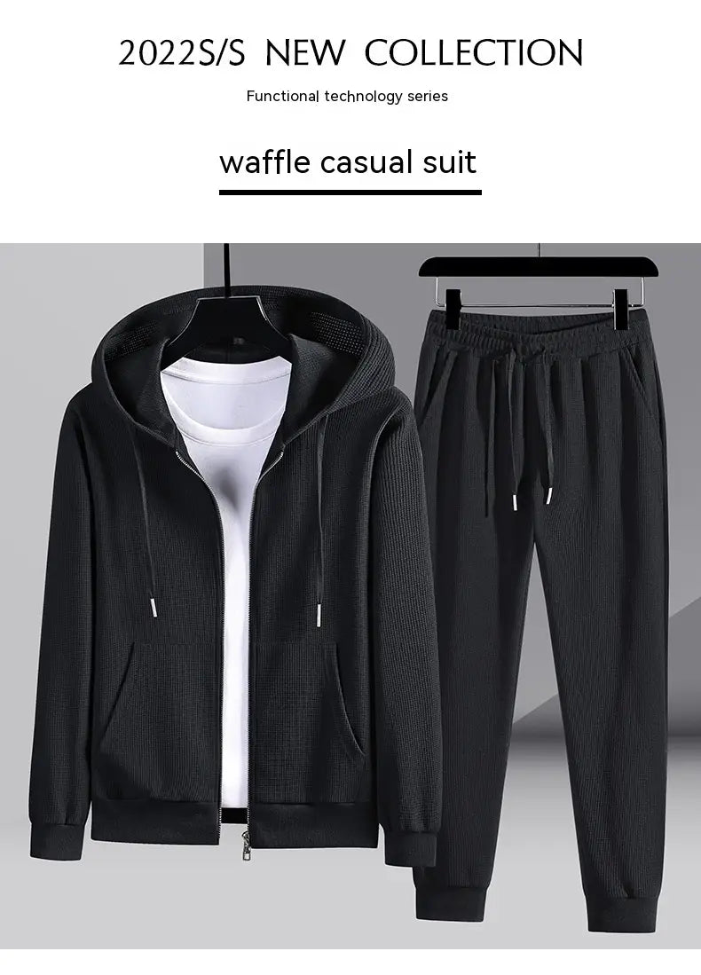Black waffle textured casual suit featuring a zip front hoodie and matching drawstring pants from the waffle hooded sportswear set.