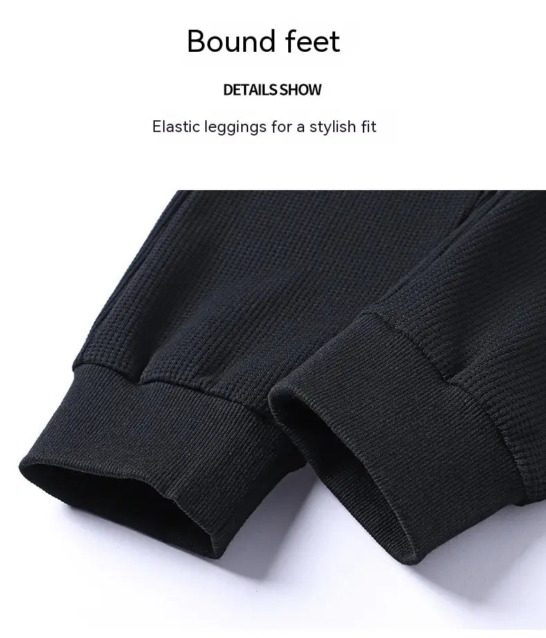 black elastic leggings with ribbed cuffs for a stylish fit as part of the waffle hooded sportswear set.