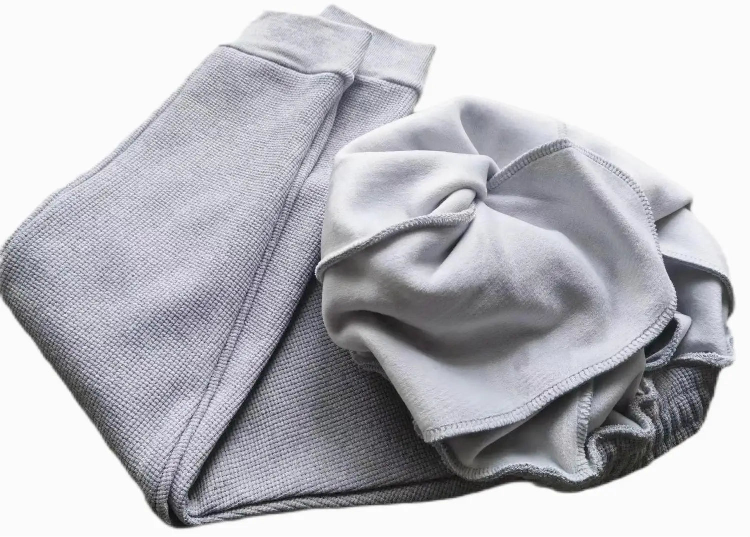 A soft heather gray sweatpant with a ribbed waistband and cuffs made of waffle fabric as part of a waffle hooded sportswear set.