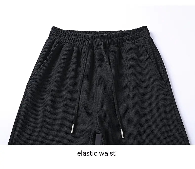 black textured knit waffle pants with elastic waistband and matching drawstrings from the waffle hooded sportswear set