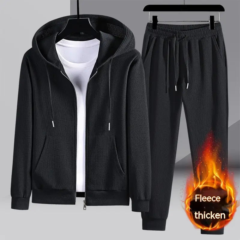 Black fleece-lined hooded zip-up jacket and matching sweatpants set made from waffle fabric for comfortable sportswear.