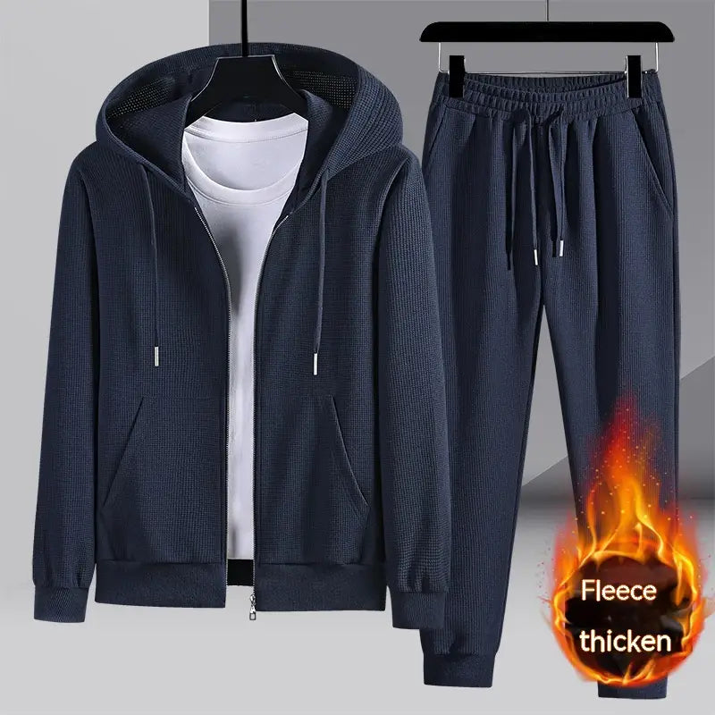 Dark navy blue fleece tracksuit with a textured knit pattern featuring a zip-up hoodie and matching joggers from the waffle hooded sportswear set.