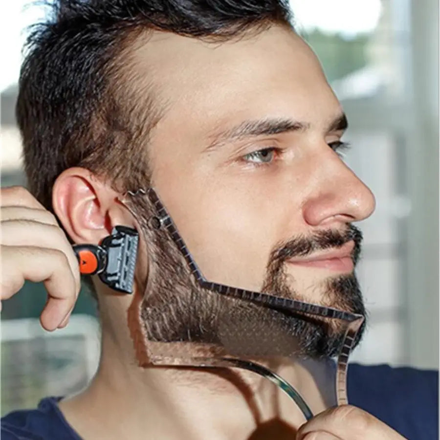 Black and orange electric beard shaping tool with a flexible transparent guide strip for precise beard trimming and shaping for men.
