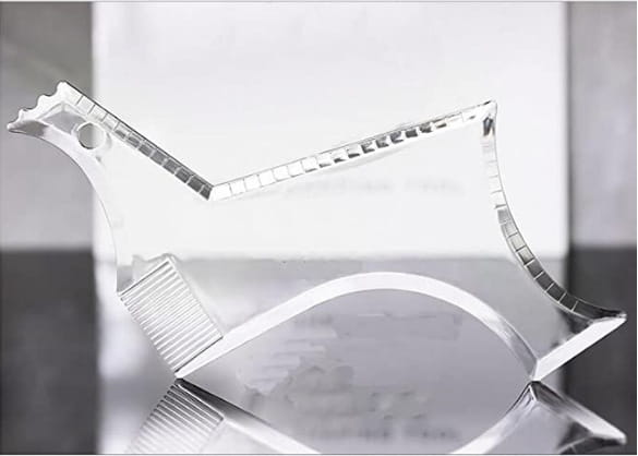 Clear acrylic beard shaping tool and template comb for men shaped like a stylized bird with textured faceted edges and a polished finish.