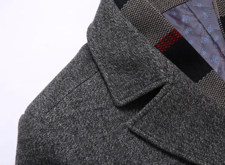 Men wool overcoat in gray wool with a textured heathered finish and structured collar designed as a winter jacket with plaid lining.