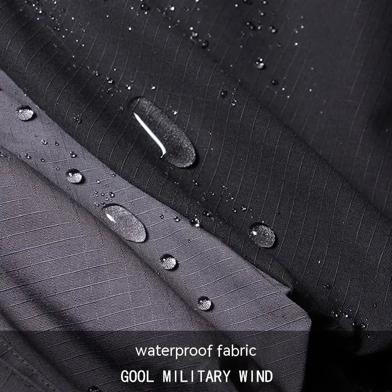 black waterproof fabric with subtle grid texture and water droplets beading up highlighting the weather-resistant properties of the tactical soft shell jacket and cargo pants suit