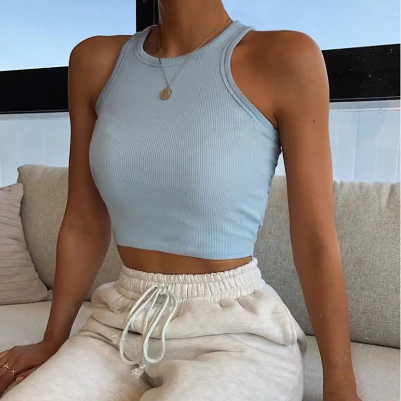 light blue ribbed knit sleeveless slim fit crop top for women shown from the back.