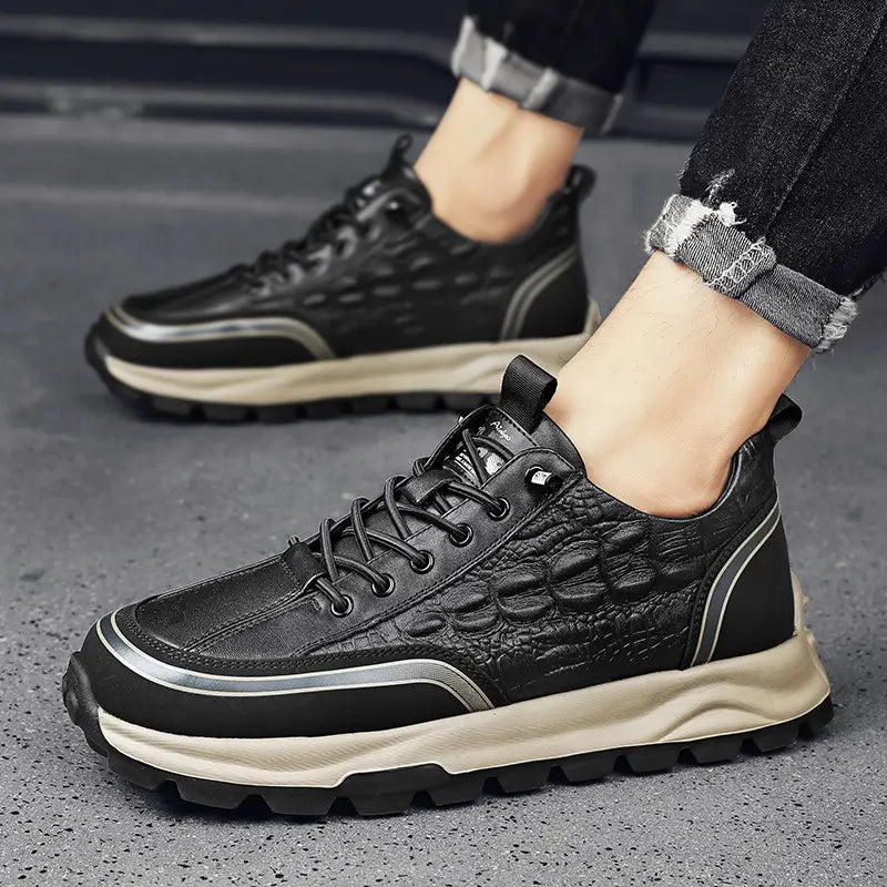 Men’s black crocodile embossed leather sneakers with beige rubber sole and silver accent stripes.