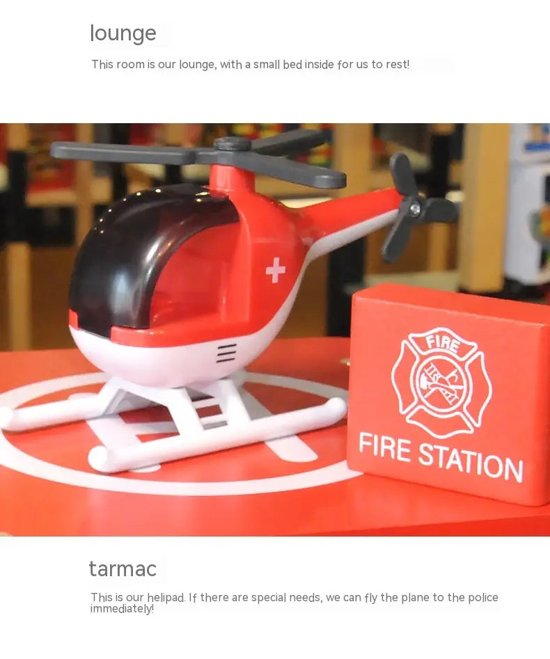 Hélicoptère-jouet en plastique rouge et blanc avec des pales de rotor noires et une croix médicale sur le côté, inclus dans un jeu d’ensemble caserne de pompiers et poste de police en bois pour enfants.