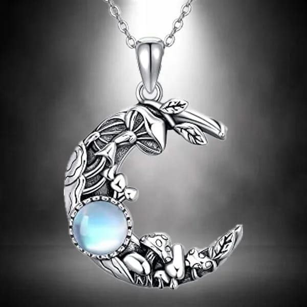 Bohemian silver crescent moon pendant necklace featuring intricate mushroom and leaf designs with a central blue moonstone.