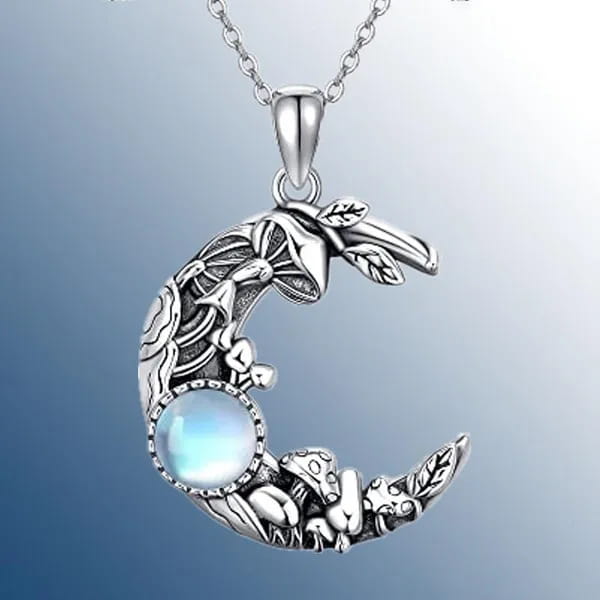 Bohemian silver crescent moon pendant necklace featuring intricate mushroom and leaf designs with a central blue moonstone.