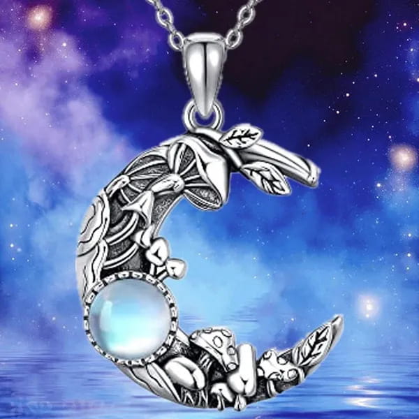 Bohemian silver crescent necklace featuring intricate mushroom and leaf designs with a central blue moonstone gemstone.