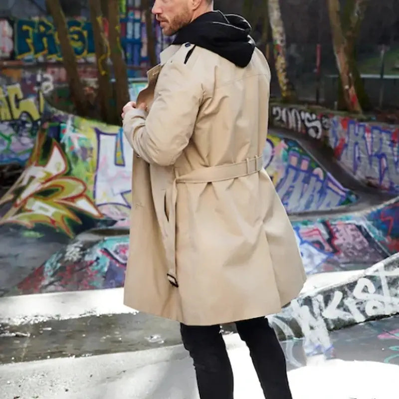 Beige slim double breasted men hooded trench coat with black hood and belt shown from the back.