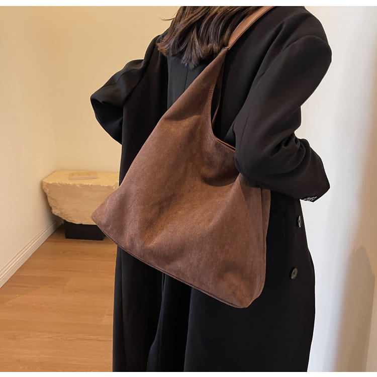 Brown suede shoulder bag with a soft slouchy design and matching strap large capacity tote bag