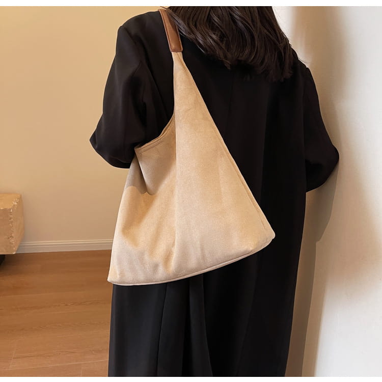 beige suede shoulder bag large capacity slouchy tote bag with a contrasting brown leather strap displayed from the front