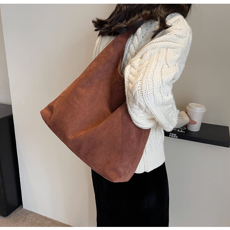 Brown suede shoulder bag with minimalist design and large capacity slouchy tote style.