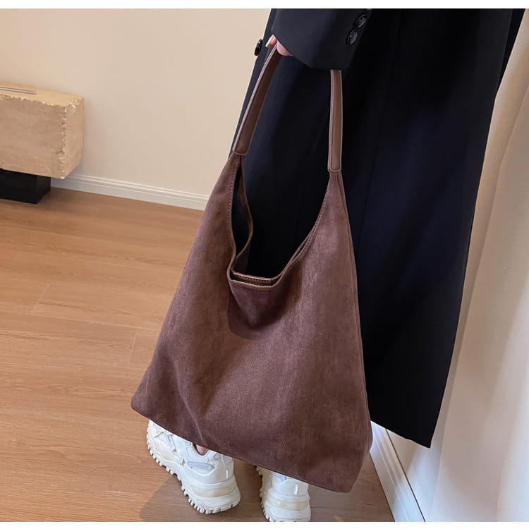 Brown suede large capacity shoulder bag with a soft slouchy design and matching handles for comfortable carrying