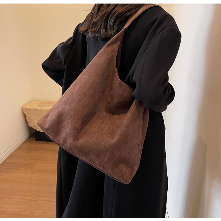 brown suede shoulder bag with large capacity and slouchy tote design showcasing a simple minimalist style