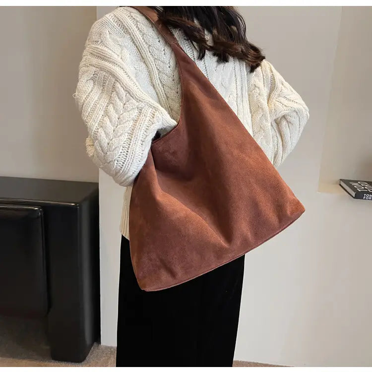Brown suede shoulder bag with a large capacity and soft slouchy design perfect for everyday use.