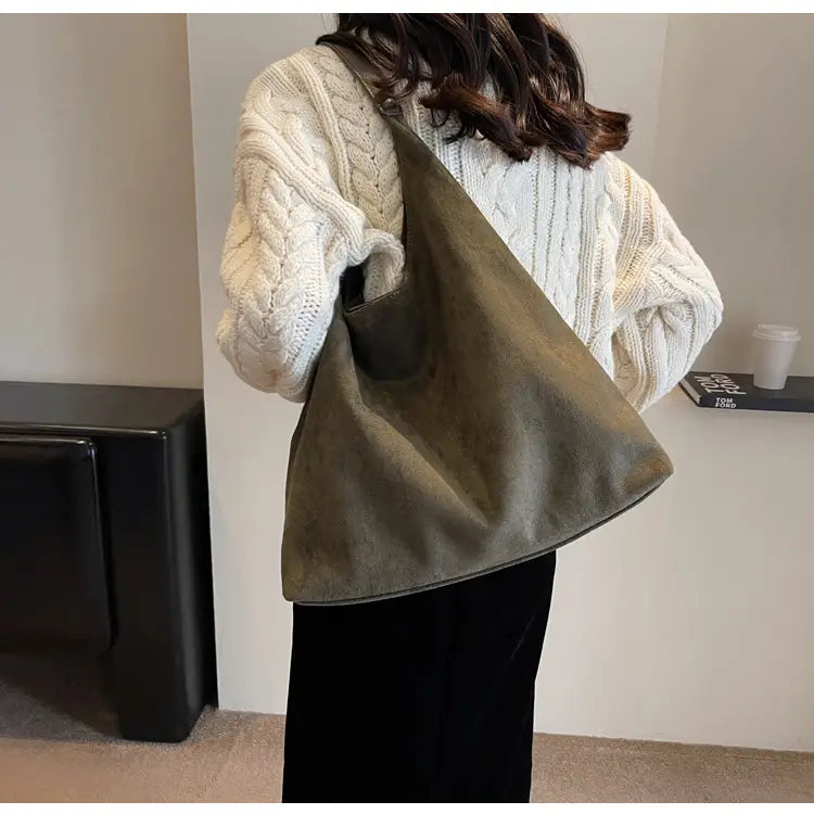Olive green suede shoulder bag with a slanted design and visible stitching details large capacity slouchy tote bag.