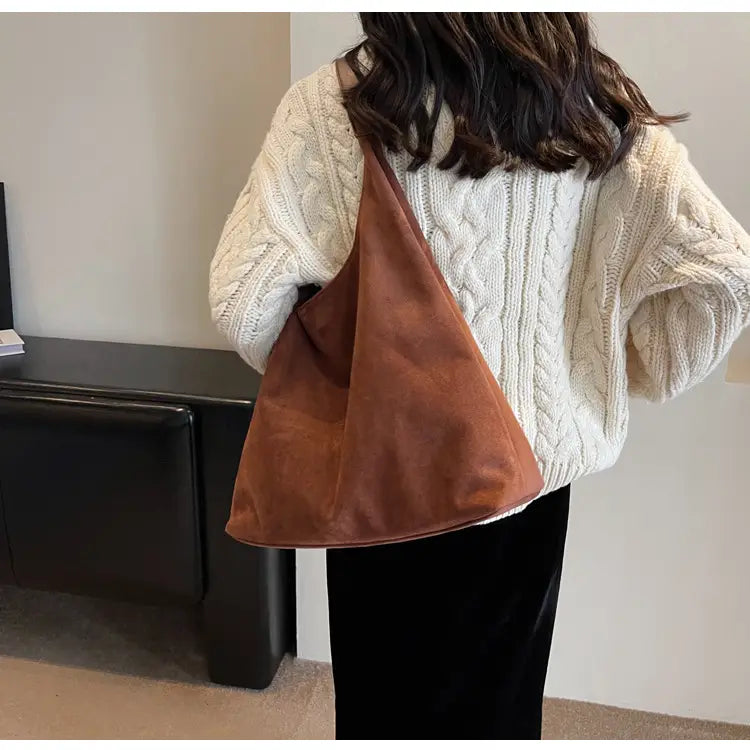 brown suede shoulder bag with a slouchy triangular shape large capacity tote design for versatile use