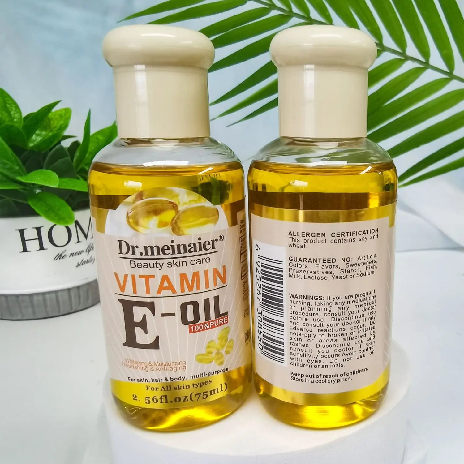 Zwei klare Kunststoffflaschen Dr.-Vitamin-E-Syntheseöl für Gesicht, Körper und Haare, 75 ml, nebeneinander präsentiert