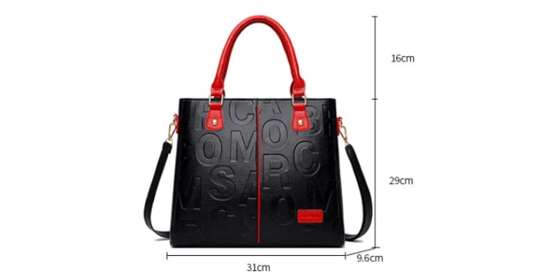 Large capacity leather embossed shoulder bag in black with red leather handles and a matching rectangular flap featuring embossed lettering across its surface.