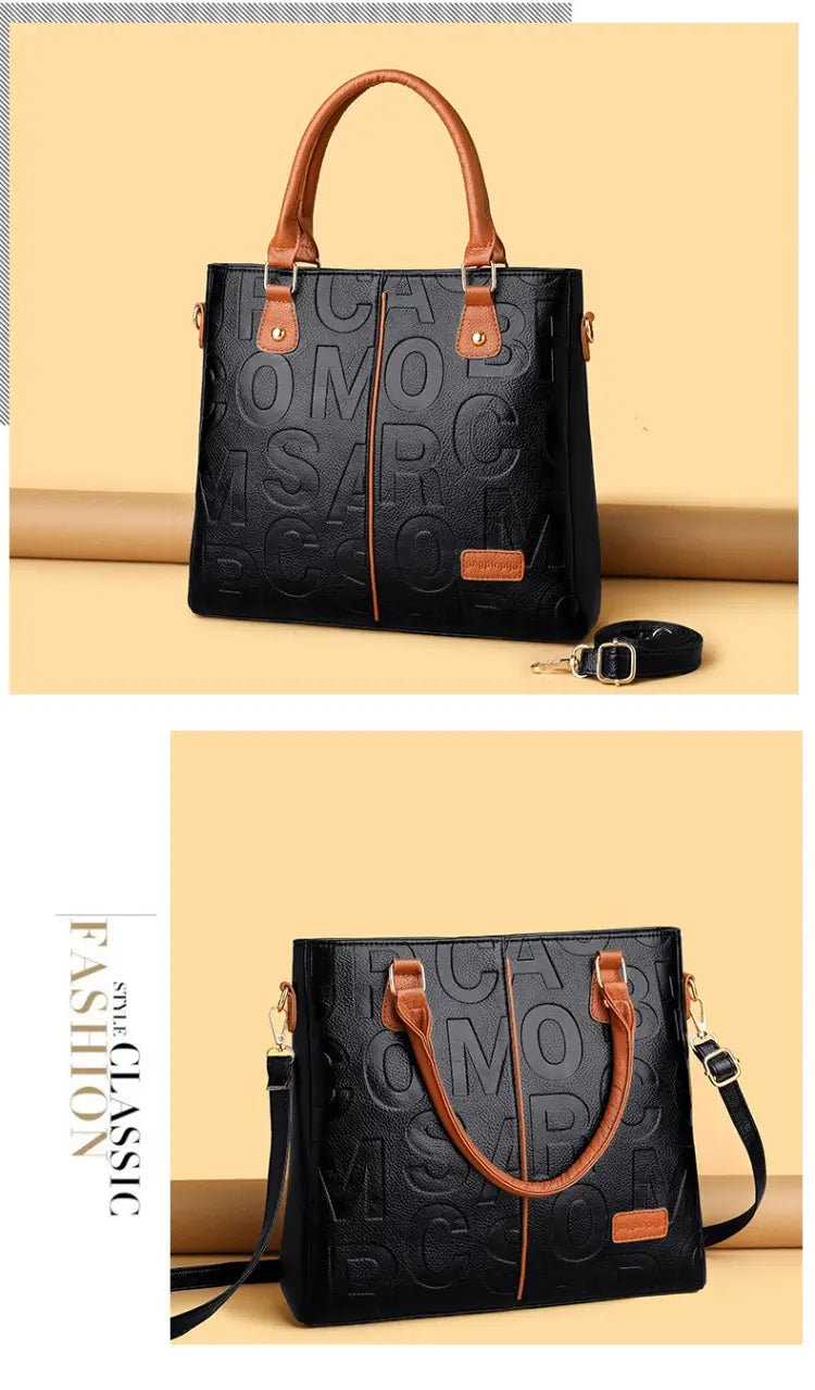 Black leather large capacity shoulder bag with tan handles and detachable strap featuring an embossed monogram pattern on the front.