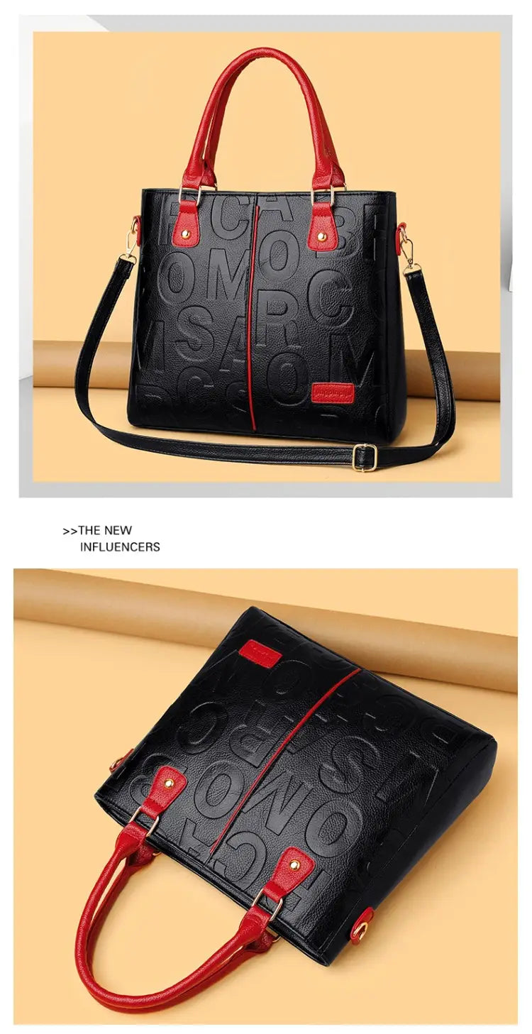 Black leather large capacity shoulder bag with red handles and trim featuring embossed lettering across the front.
