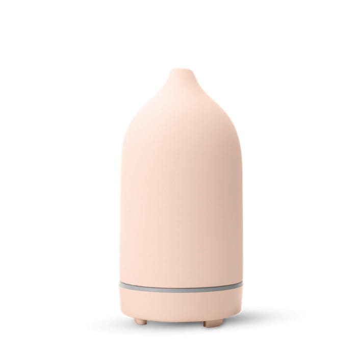 A sleek blush-pink ceramic ultrasonic aroma diffuser and humidifier with a minimalist design and a subtle gray accent band near the base.