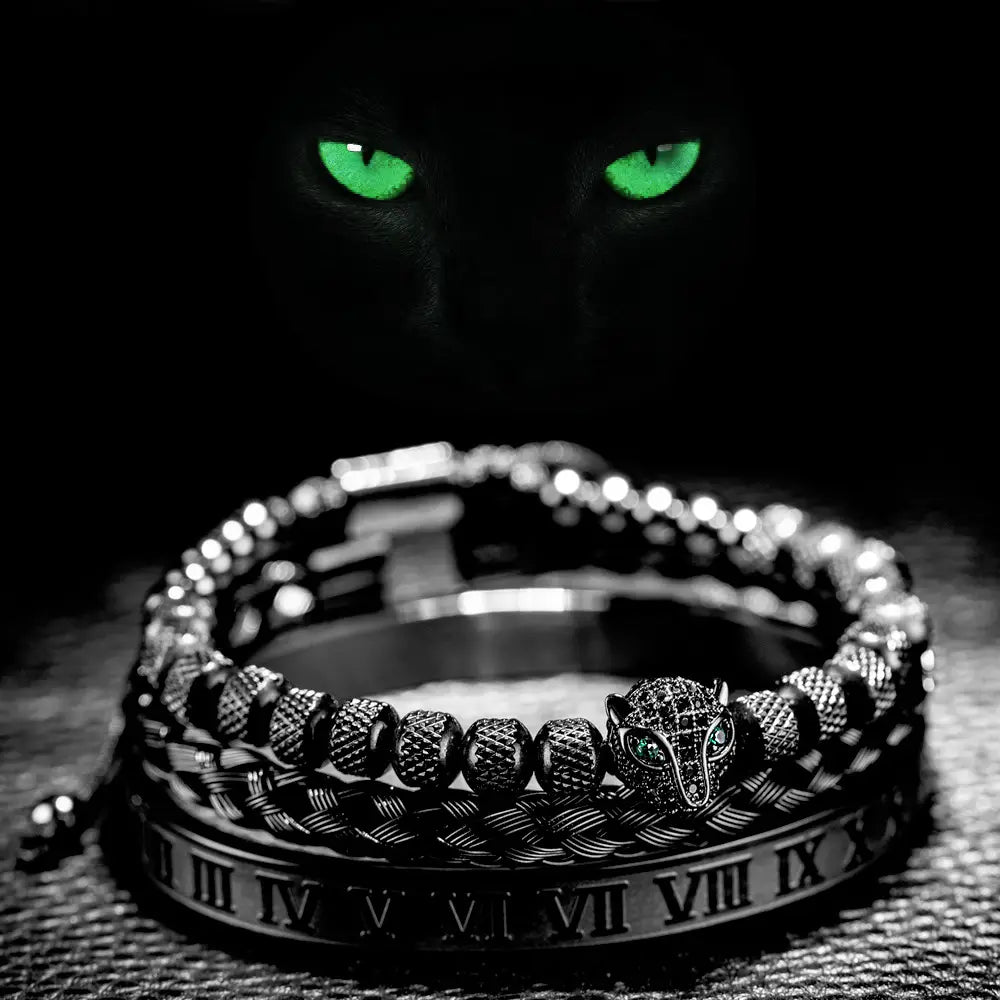 Black metal bracelet with a detailed fox head charm and roman numeral engraving in a roman numeral leopard head braided leather bracelet set.