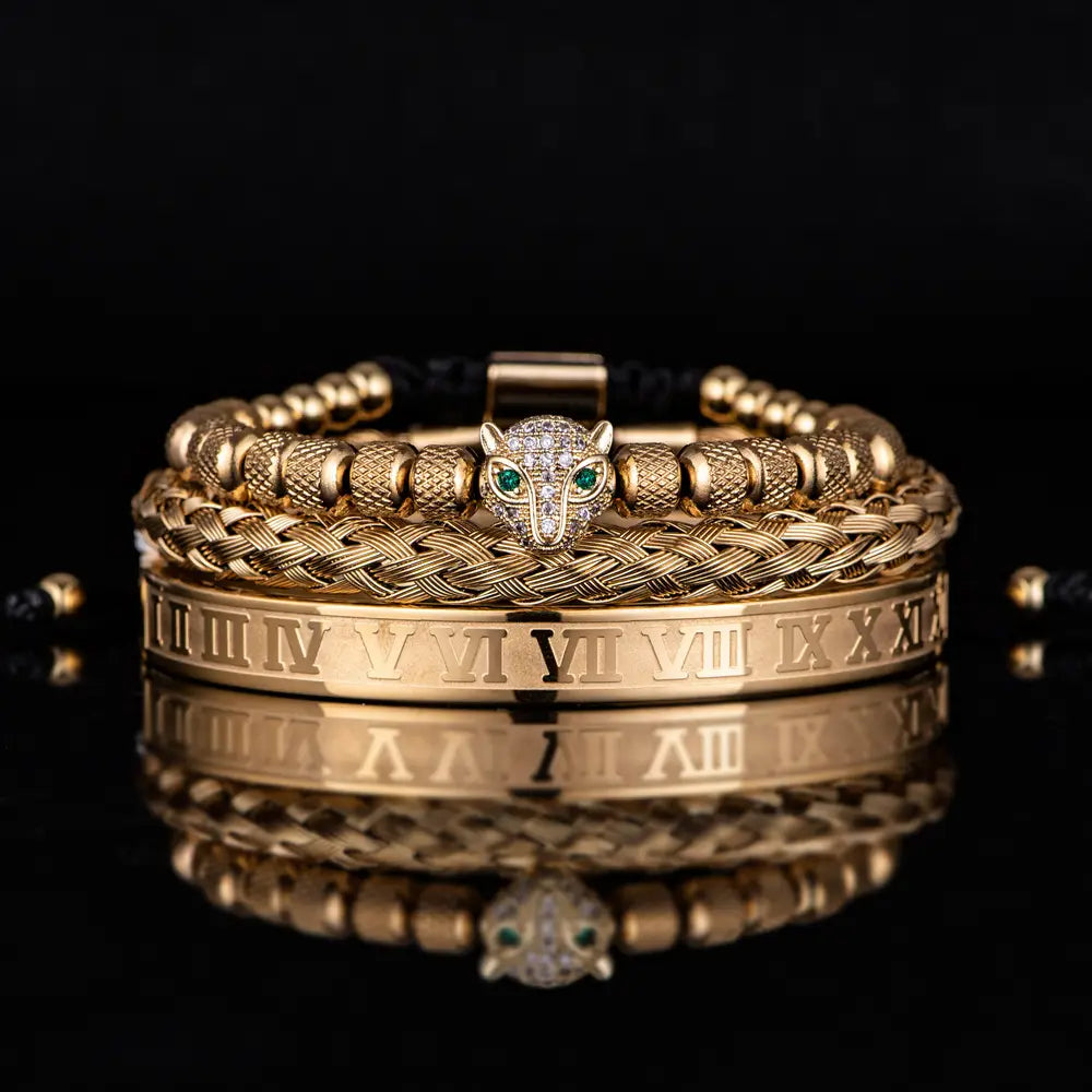 gold-toned roman numeral leopard head braided leather bracelet set featuring a central leopard head charm with green gemstone eyes and surrounding braided and beaded bands adorned with roman numerals.
