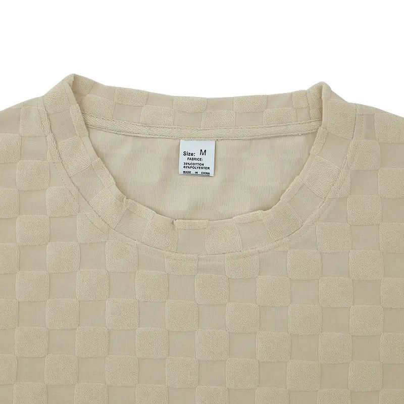 Beige textured geometric cotton blend t-shirt and shorts set featuring a woven-textured top with a subtle checkered pattern and soft breathable fabric.