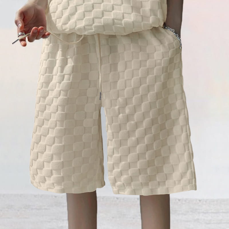 Cream-colored shorts with a textured woven pattern in a textured geometric cotton blend t-shirt and shorts set.