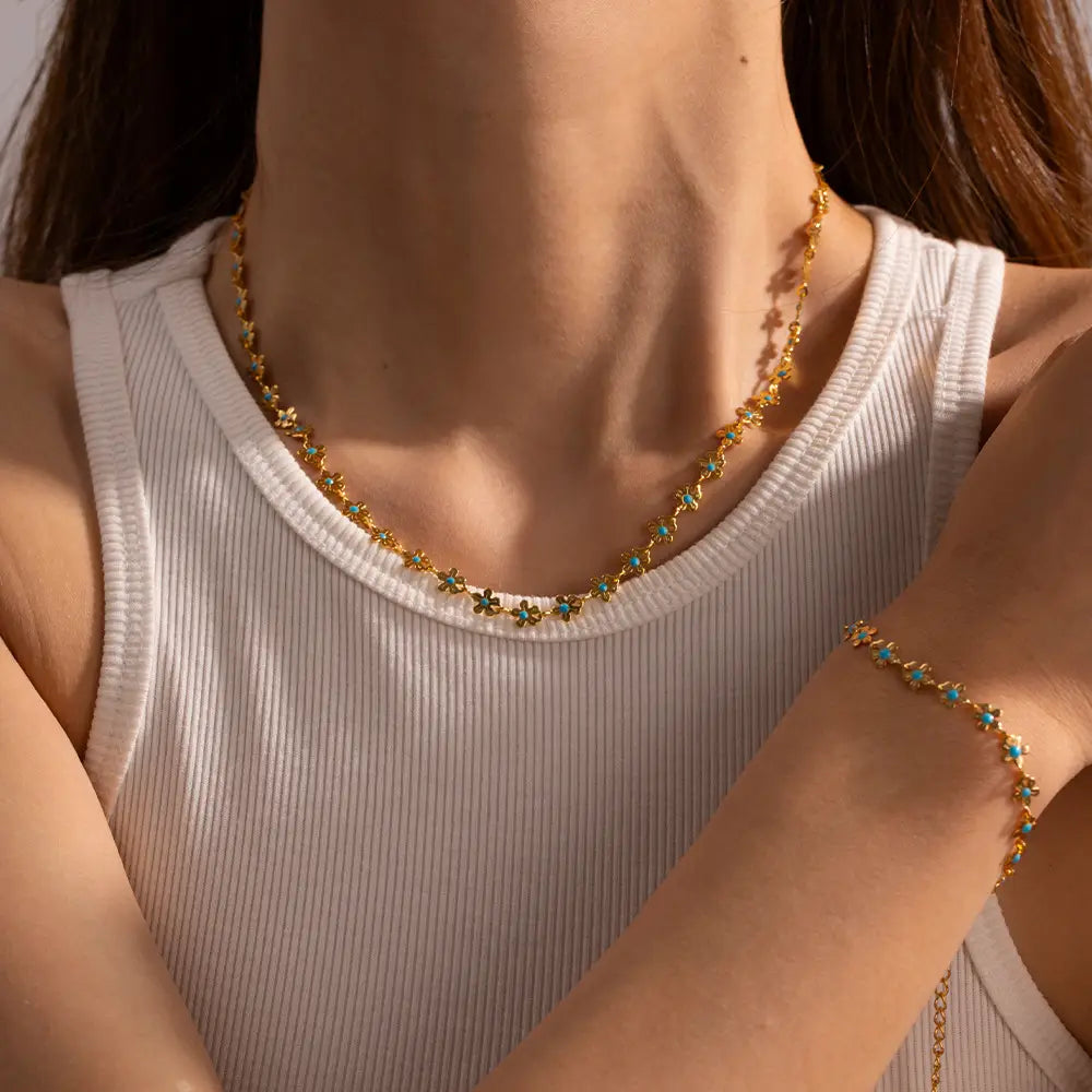 Gold-toned turquoise daisy gold chain necklace and bracelet set featuring delicate star-shaped charms accented by turquoise stones.