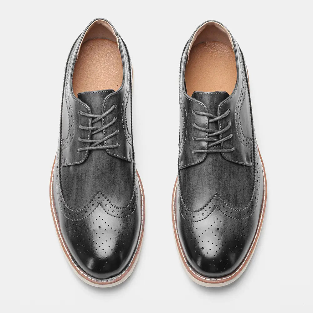 Men’s brogue casual leather sneakers in black with perforated detailing and a tan sole designed for lightweight comfort.