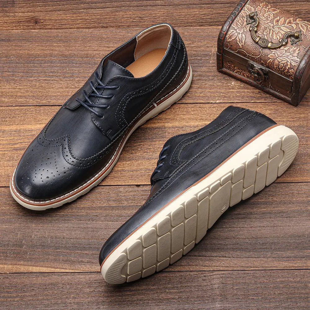 men’s brogue casual leather sneakers in black with perforated detailing and a contrasting cream-colored rubber sole designed for lightweight comfort.