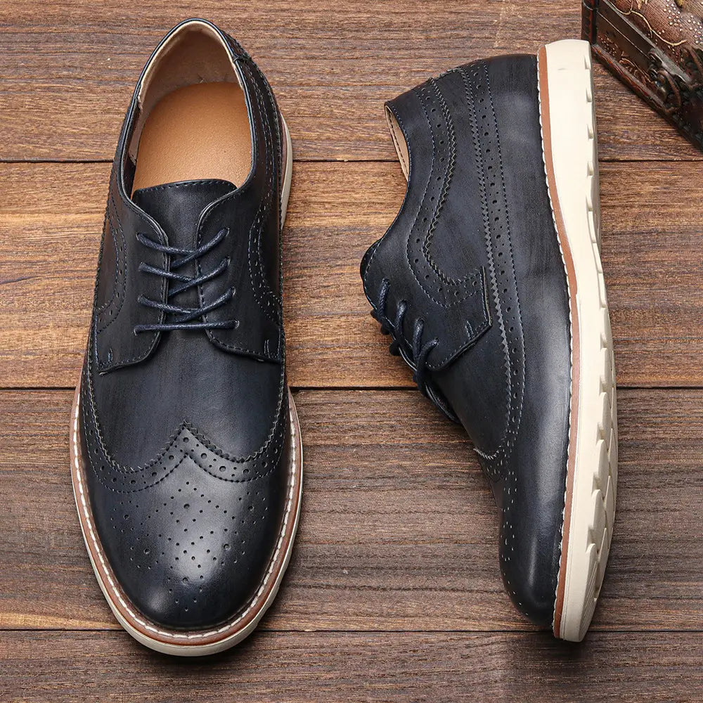 Men’s brogue casual leather sneakers in black with perforated detailing and a white rubber sole designed for lightweight comfort.